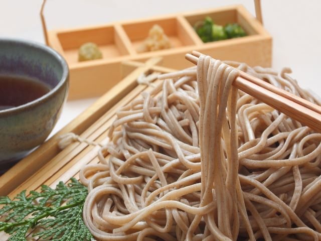 Buckwheat noodle improver for enhanced flavor and reduced buckwheat flour content